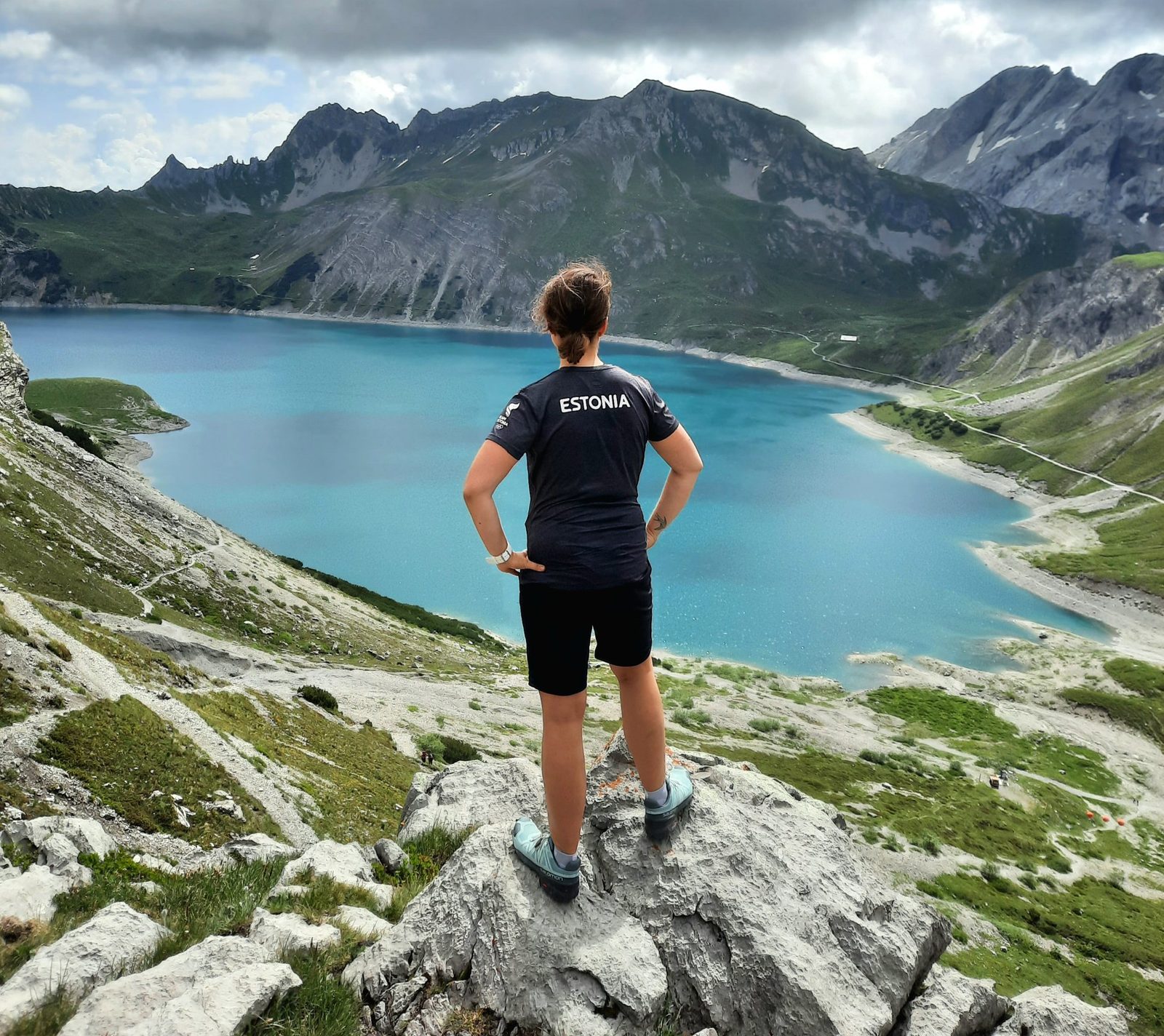 Katharina looking out over a mountain lake